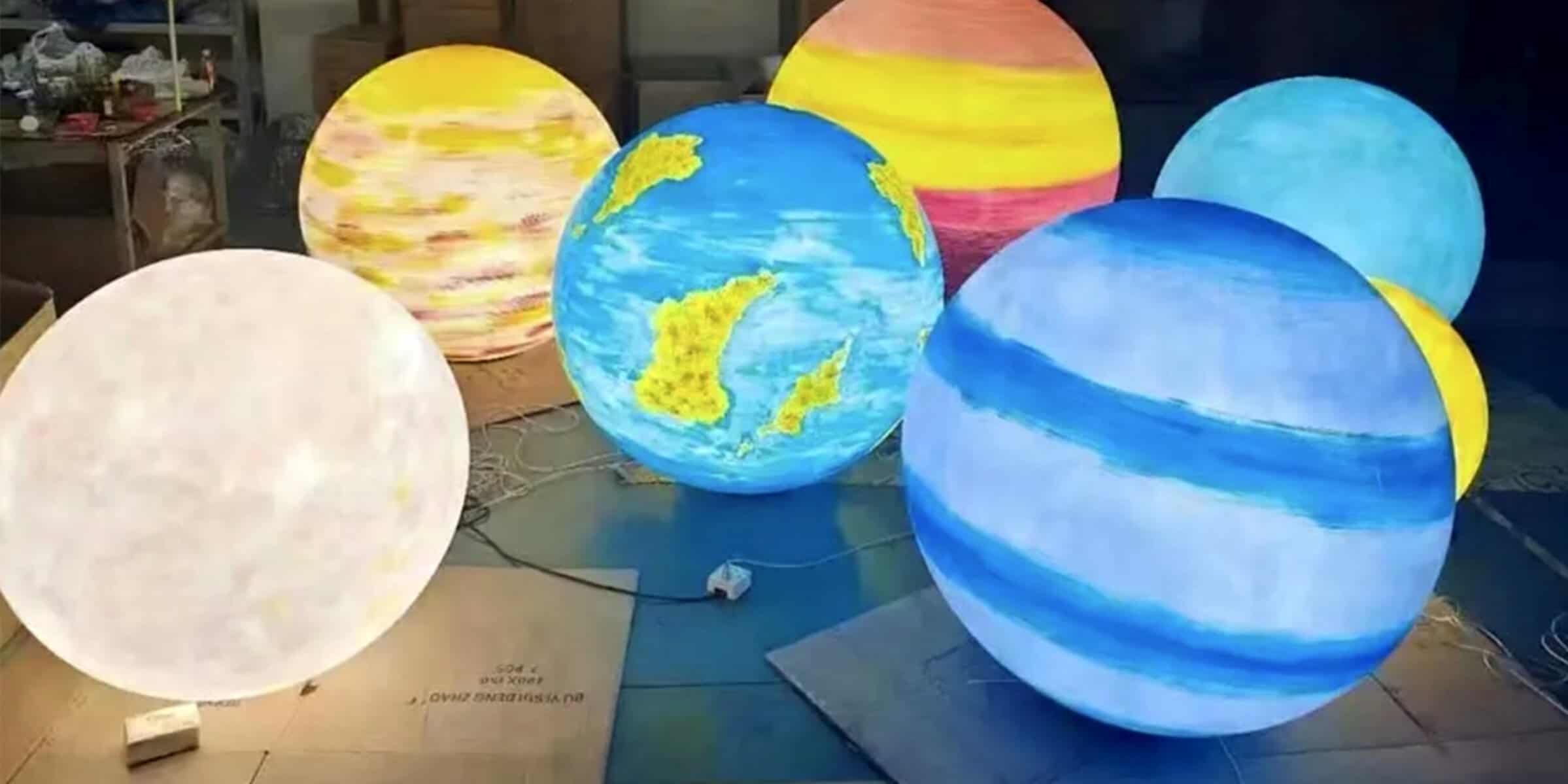 Colorful illuminated globe lamps with artistic designs, perfect for home décor, events, and creative spaces. Handcrafted paper lanterns showcasing vibrant patterns and world maps.