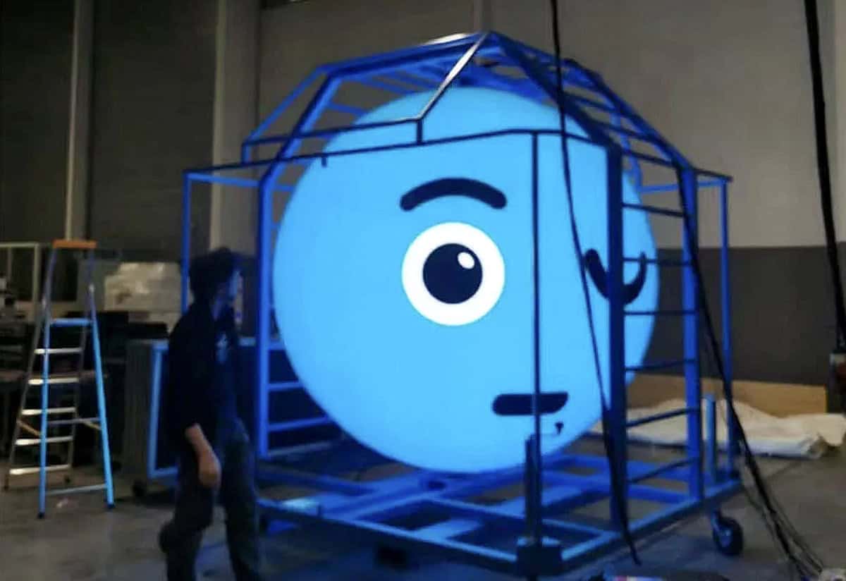 Large illuminated mascot face construction for event branding or promotional display.