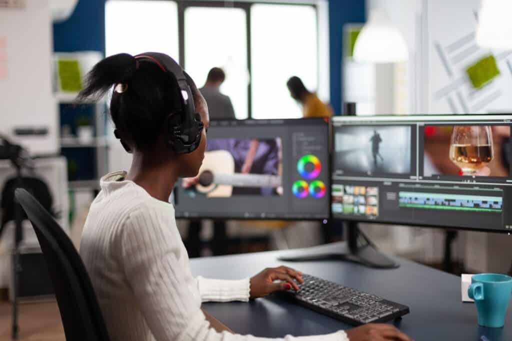 High-end video editing workspace with professional monitors and editing software at TriVision Studios.