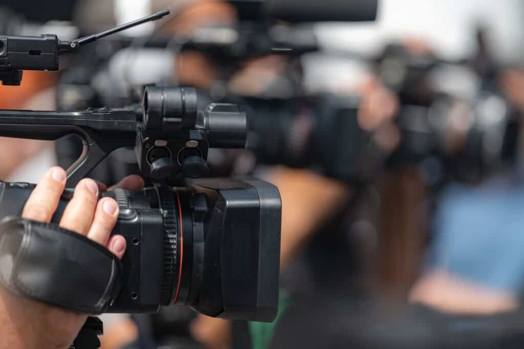 Close-up of professional video camera on set, showcasing advanced filming gear used in video production, film shoots, and studio projects at TriVision Studios.