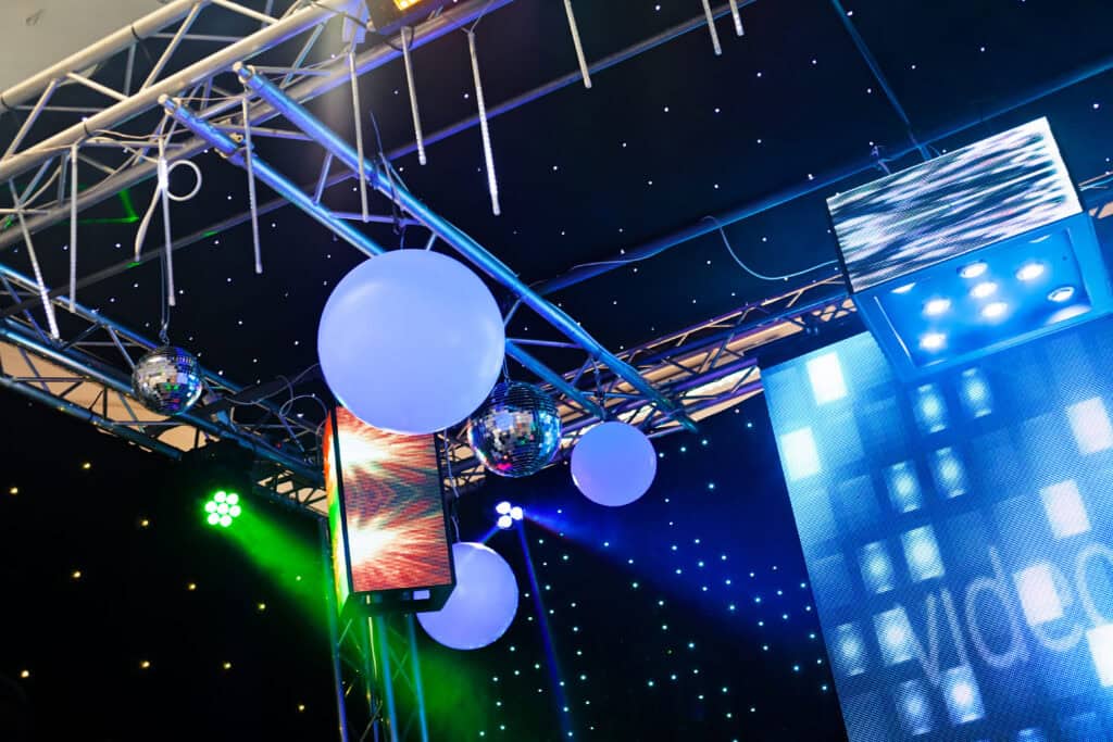 Vibrant stage lighting with LED screens, disco balls, and decorative lights for events and productions. Perfect for creating an energetic atmosphere in any venue.
