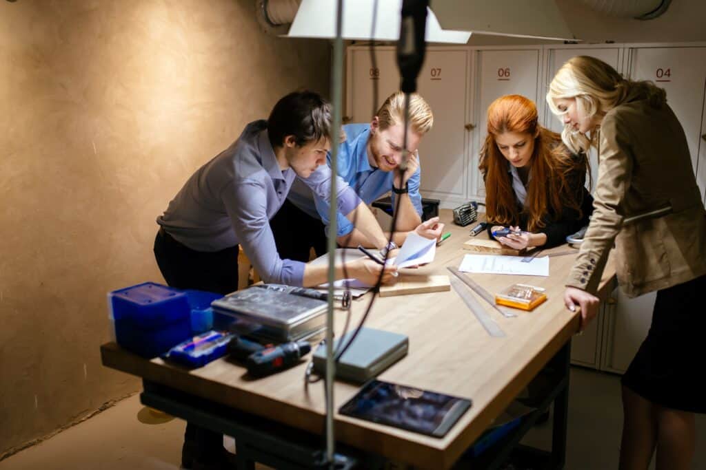 Professional film crew collaborating in a video production studio setting, focusing on planning and scripting for high-quality content creation.