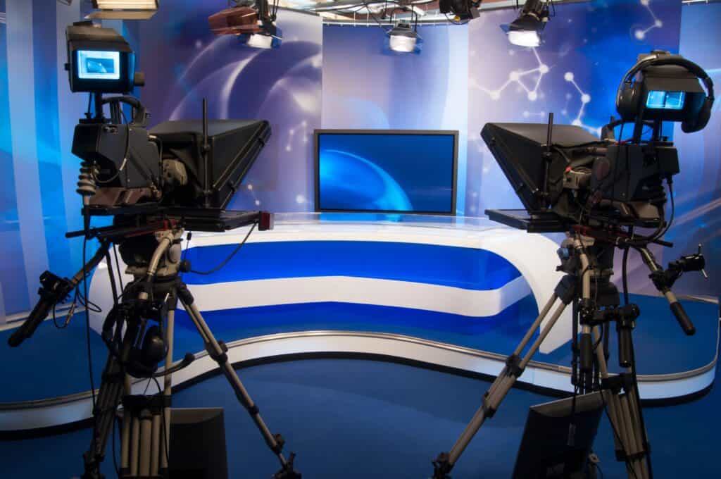 High-tech broadcast studio with professional cameras and digital monitors for seamless video production and live streaming.