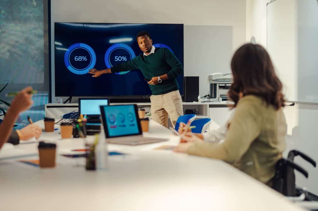 A diverse team collaborating on a digital marketing presentation at TriVision Studios, specializing in professional video production and creative media solutions.