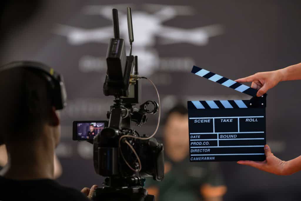 Professional video production setup with camera and clapperboard at TriVision Studios, showcasing high-quality filming and editing services.
