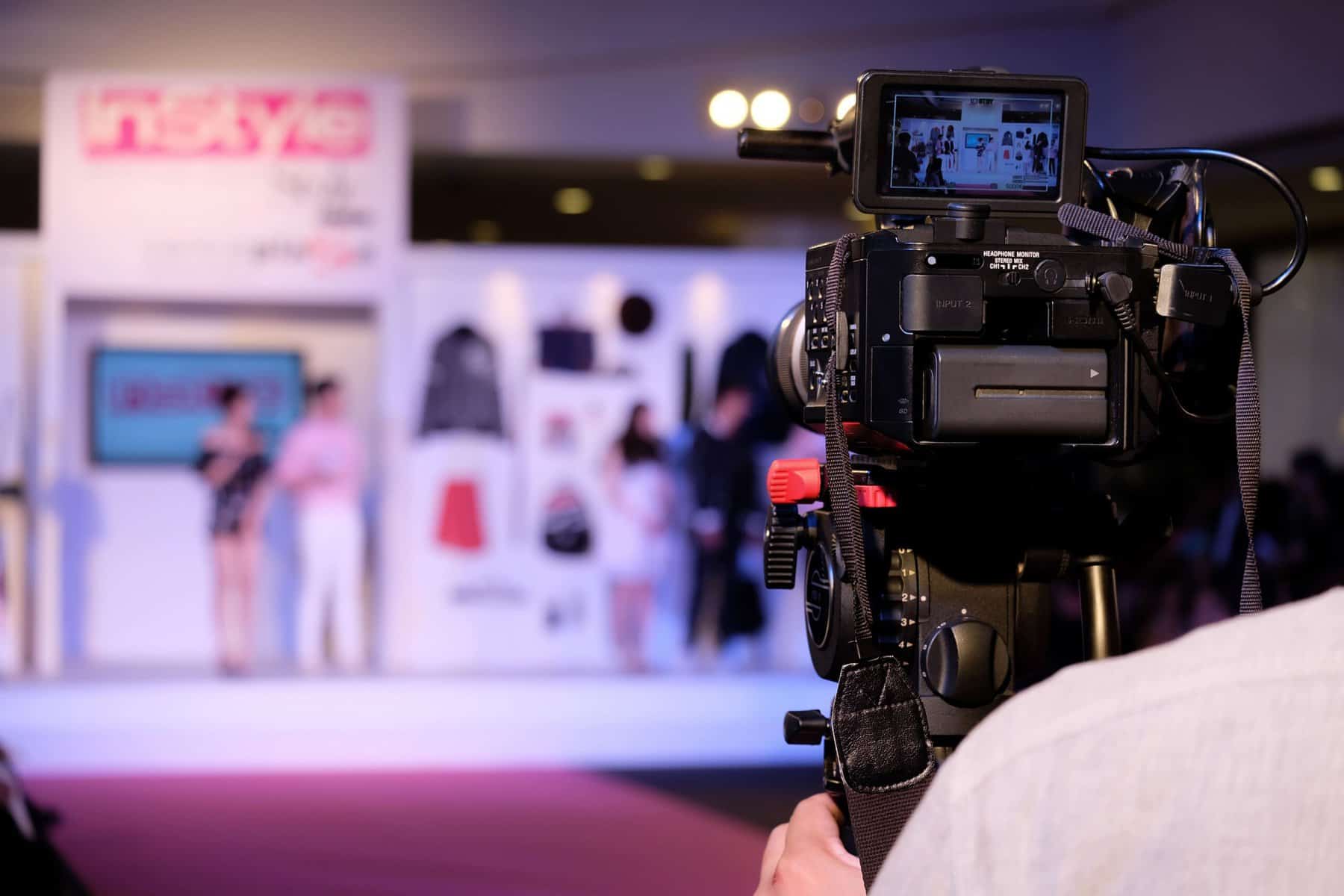 Camera capturing professional video footage at TriVision Studios event.