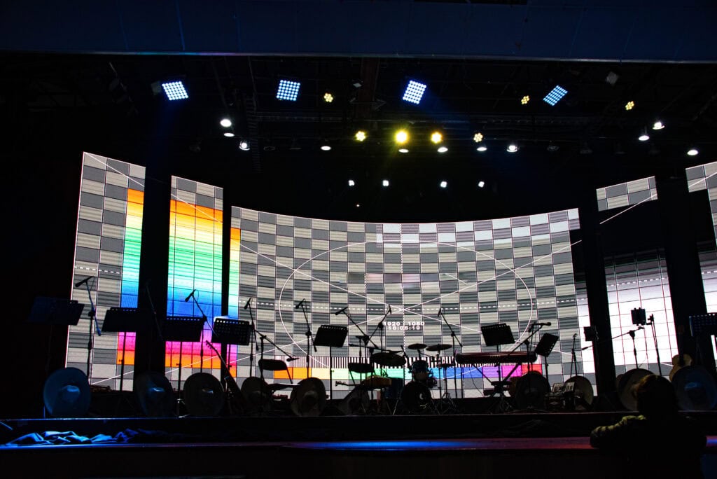 LED stage setup with colorful visuals and professional sound equipment for concerts and events.