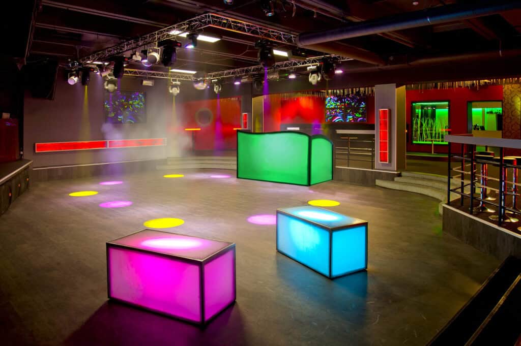 Modern event space with colorful illuminated cubes and vibrant lighting effects.